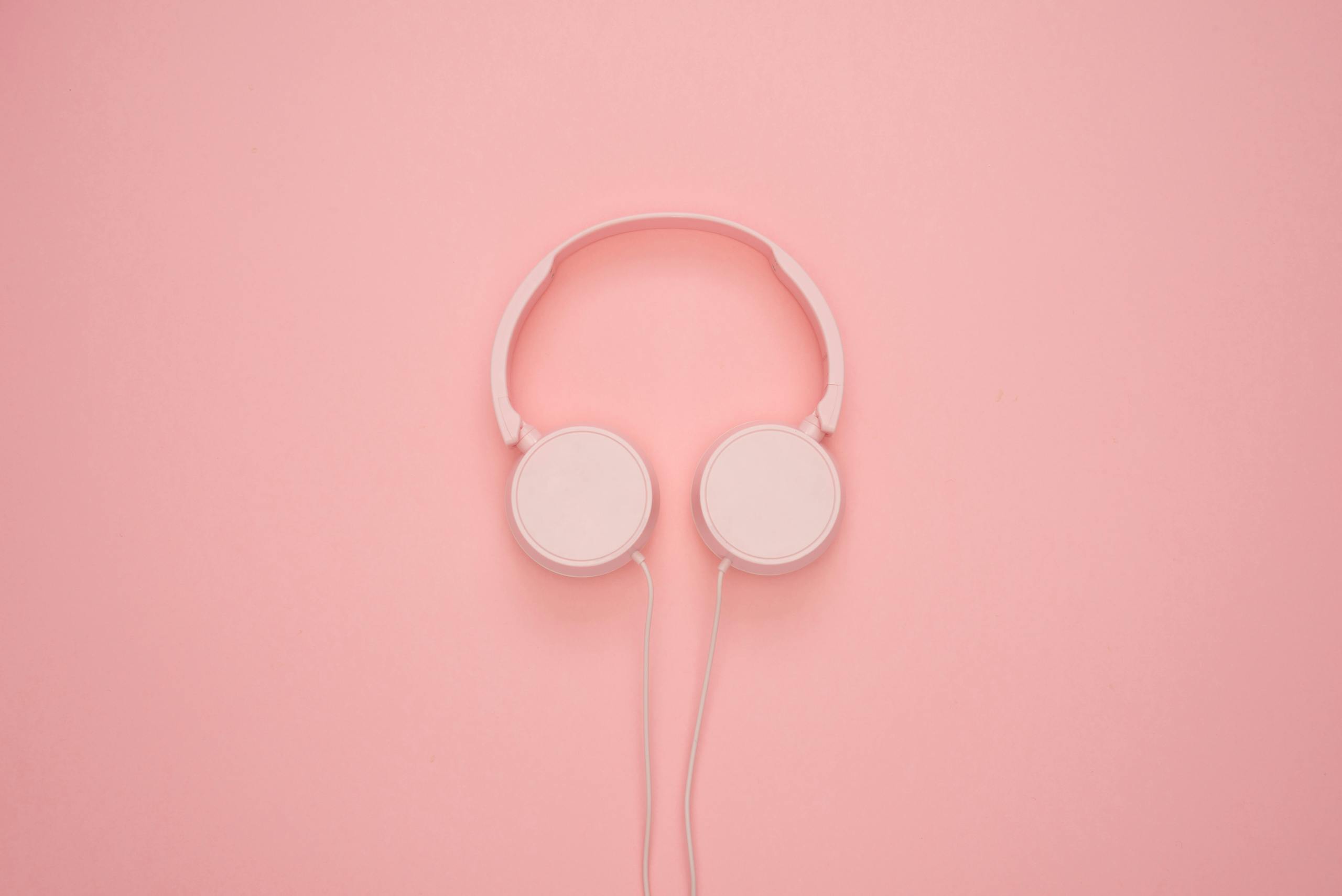 Aesthetic pink headphones on a pastel background, perfect for a modern and stylish look.